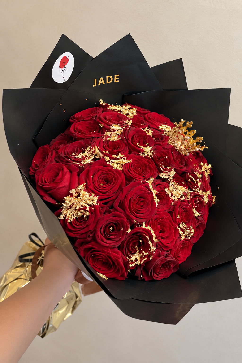 Bouquet ORNELA de roses rouges fraîches et feuilles d'or, vue détaillée