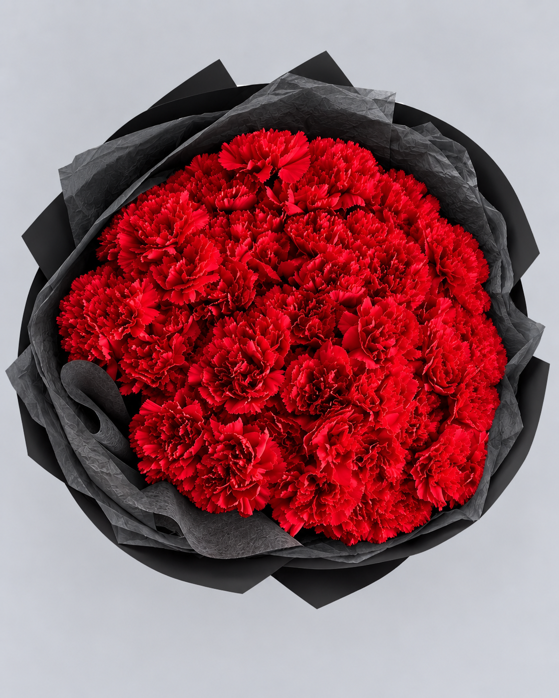 Bouquet Mimi d'œillets rouges vu du dessus dans son papier noir